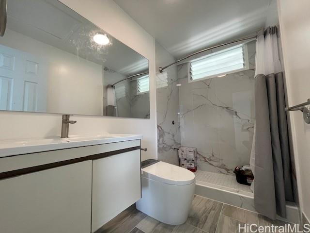 1565 Moani Street Honolulu, HI 96819 - Photo 7 of 22 a bathroom with a sink a toilet and shower