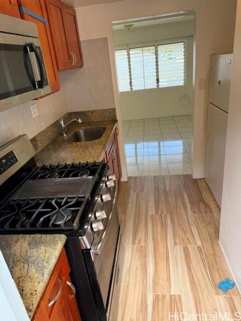 1565 Moani Street Honolulu, HI 96819 - Photo 10 of 22 a kitchen with a wooden floor and a stove top oven