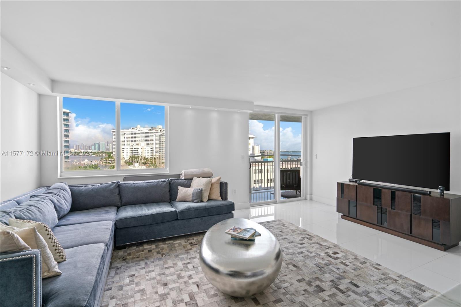 1621 Bay Road, Unit 702 Miami Beach, FL 33139 - Photo 3 of 32 a living room with furniture and a flat screen tv