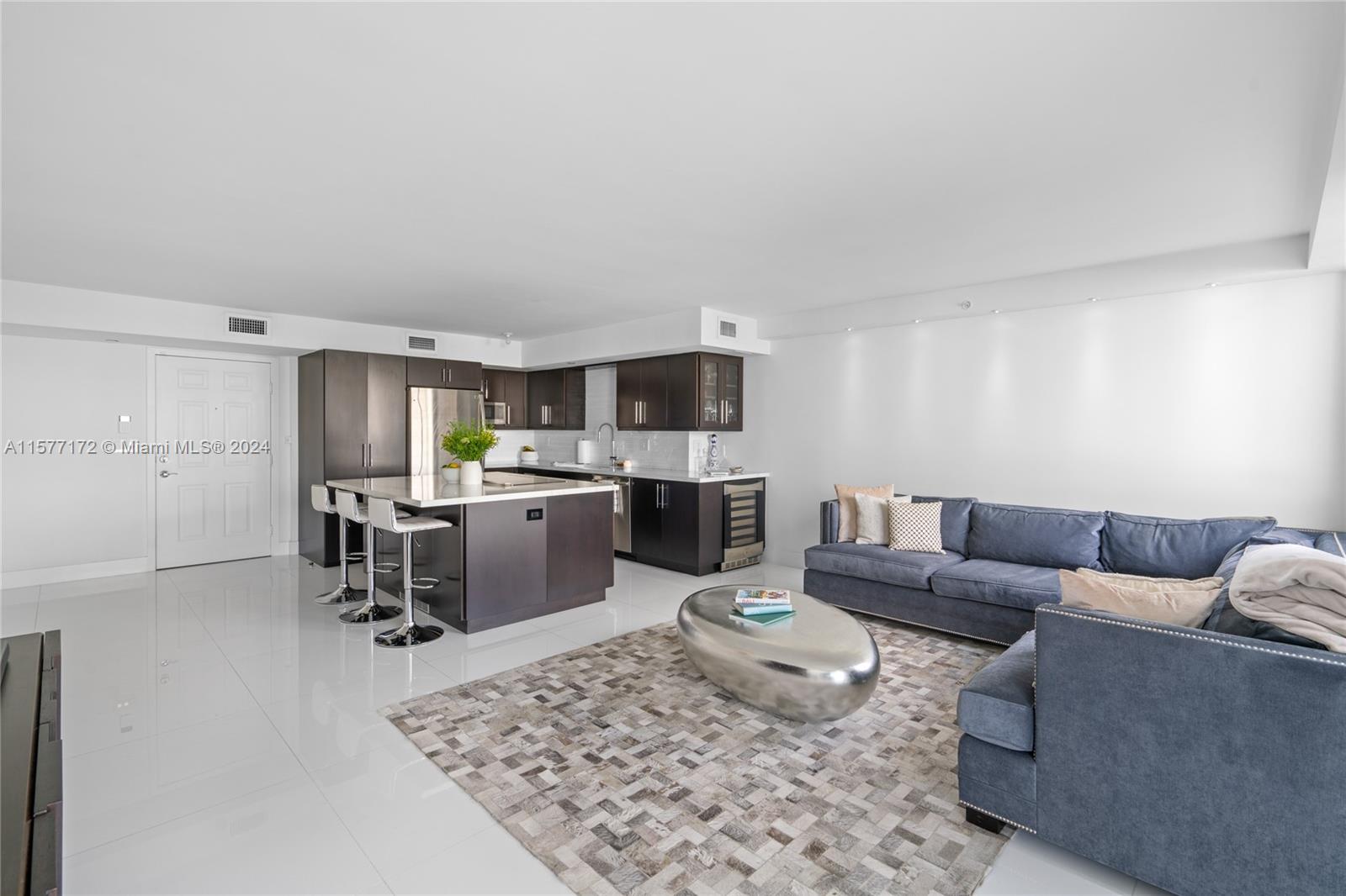 1621 Bay Road, Unit 702 Miami Beach, FL 33139 - Photo 5 of 32 a living room with furniture and kitchen view