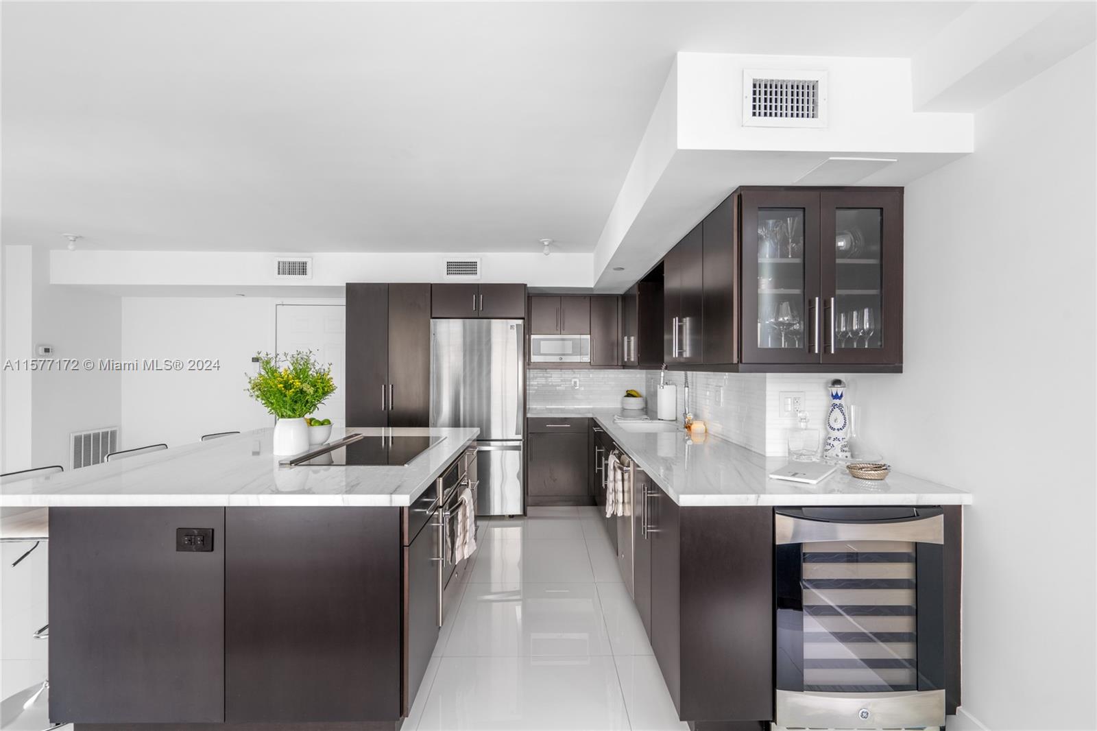 1621 Bay Road, Unit 702 Miami Beach, FL 33139 - Photo 8 of 32 a kitchen with a sink stove and refrigerator
