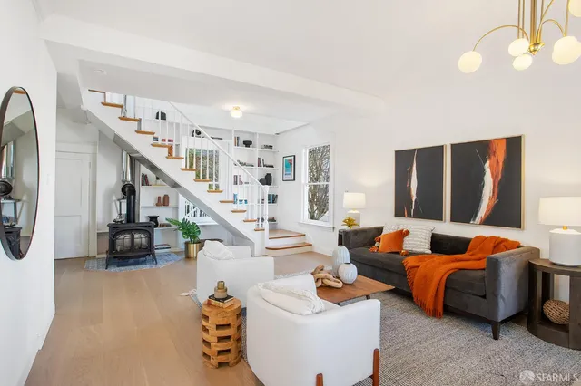 a living room with furniture and stairs