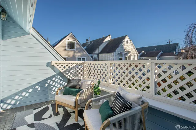 a view of balcony with wooden benches