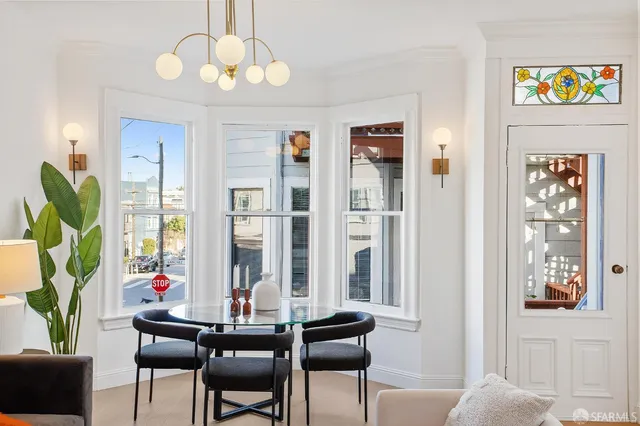 a view of a dining room with furniture window and wooden floor