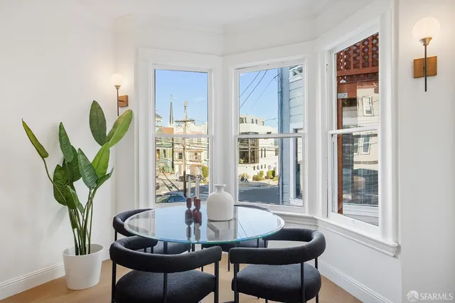 a dining room with furniture and wooden floor