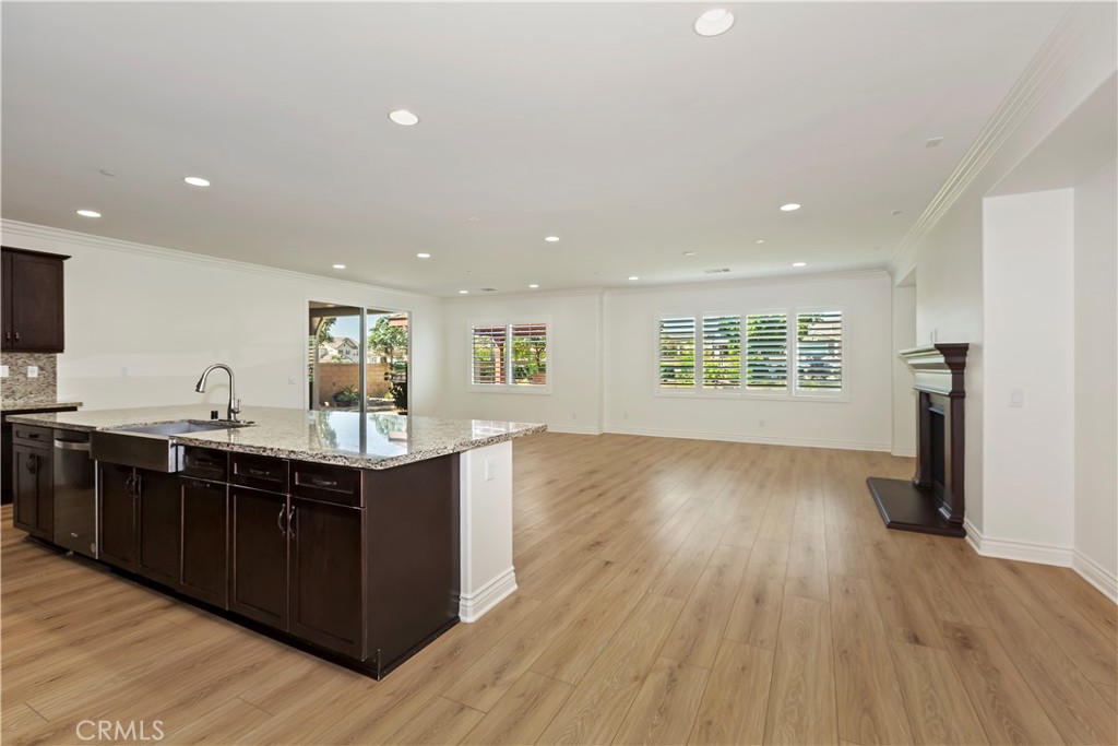 6336 Sloane Court Rancho Cucamonga, CA 91739 - Photo 18 of 69 a view of kitchen with stainless steel appliances granite countertop a sink and wooden floor