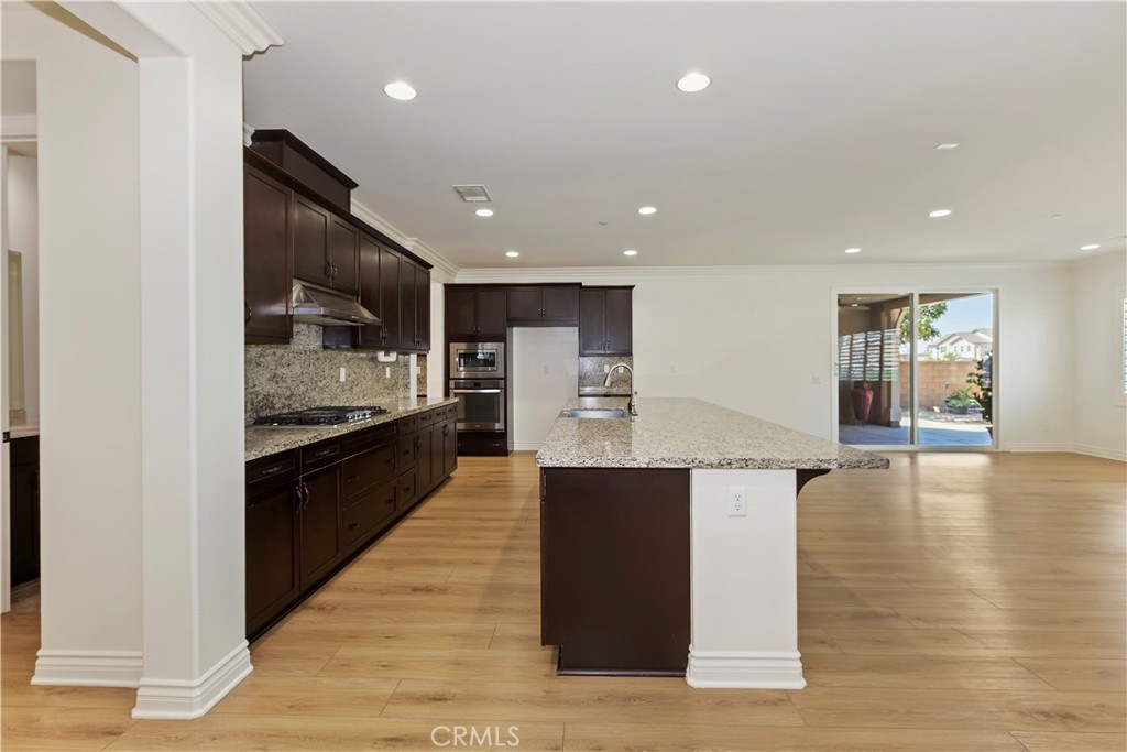 6336 Sloane Court Rancho Cucamonga, CA 91739 - Photo 19 of 69 a open kitchen with stainless steel appliances kitchen island granite countertop a large counter top and a stove top oven