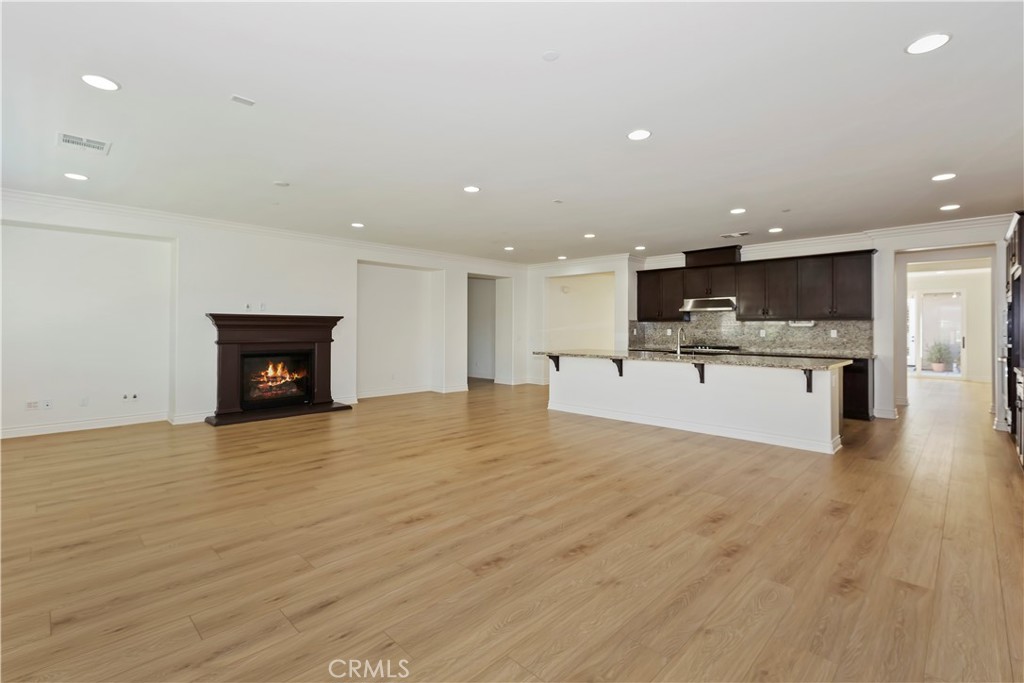 6336 Sloane Court Rancho Cucamonga, CA 91739 - Photo 25 of 69 a view of kitchen and kitchen with a sink wooden floor and a window