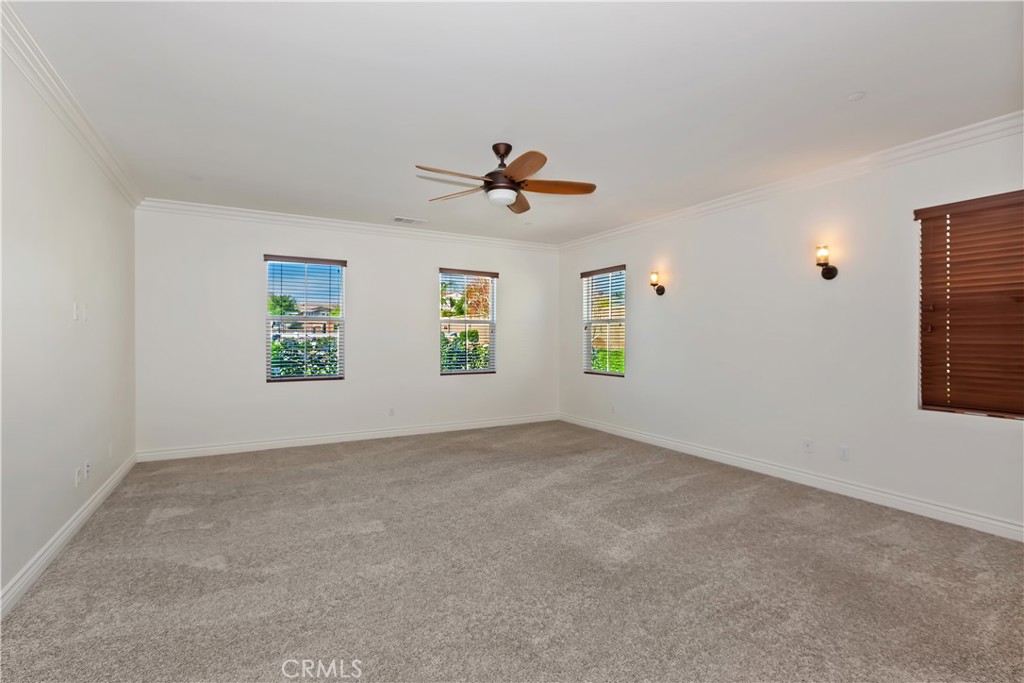 6336 Sloane Court Rancho Cucamonga, CA 91739 - Photo 28 of 69 an empty room with windows and chandelier fan