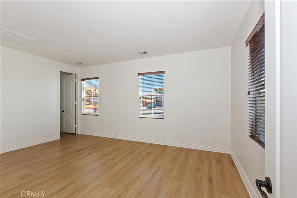 6336 Sloane Court Rancho Cucamonga, CA 91739 - Photo 39 of 69 a view of an empty room with wooden floor and a window