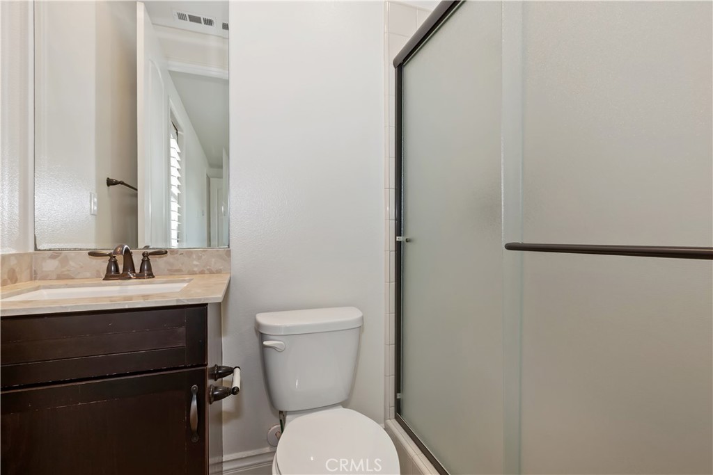 6336 Sloane Court Rancho Cucamonga, CA 91739 - Photo 43 of 69 a bathroom with a toilet a sink and mirror