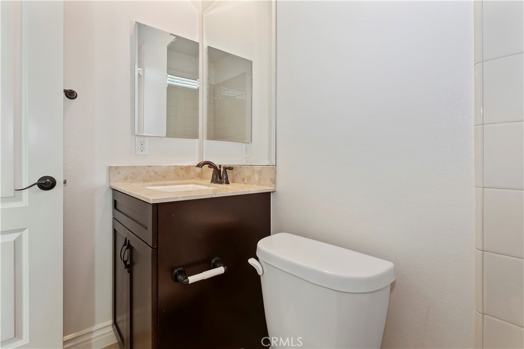6336 Sloane Court Rancho Cucamonga, CA 91739 - Photo 44 of 69 a bathroom with a sink a toilet and a mirror