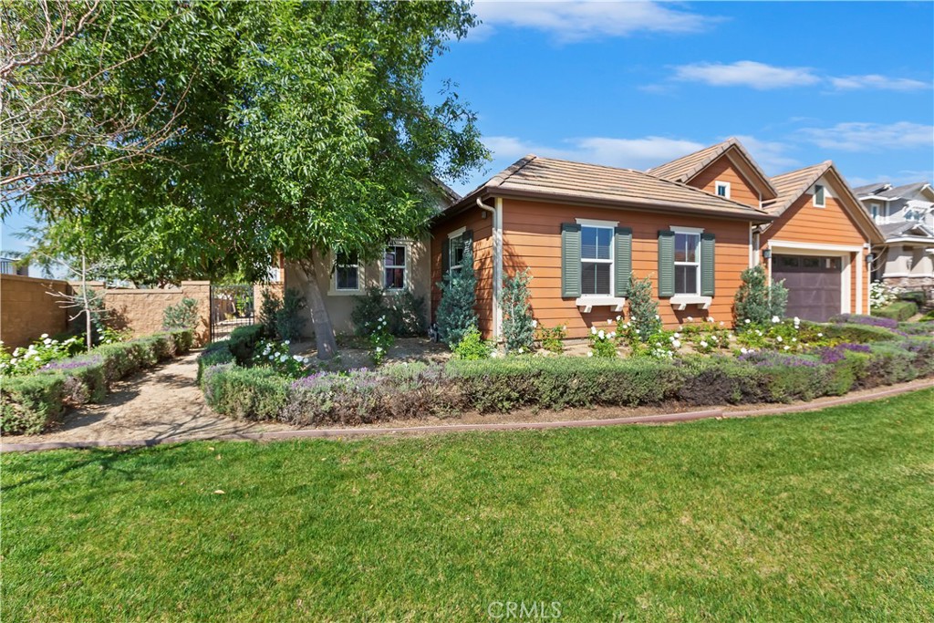6336 Sloane Court Rancho Cucamonga, CA 91739 - Photo 5 of 69 a front view of a house with a garden