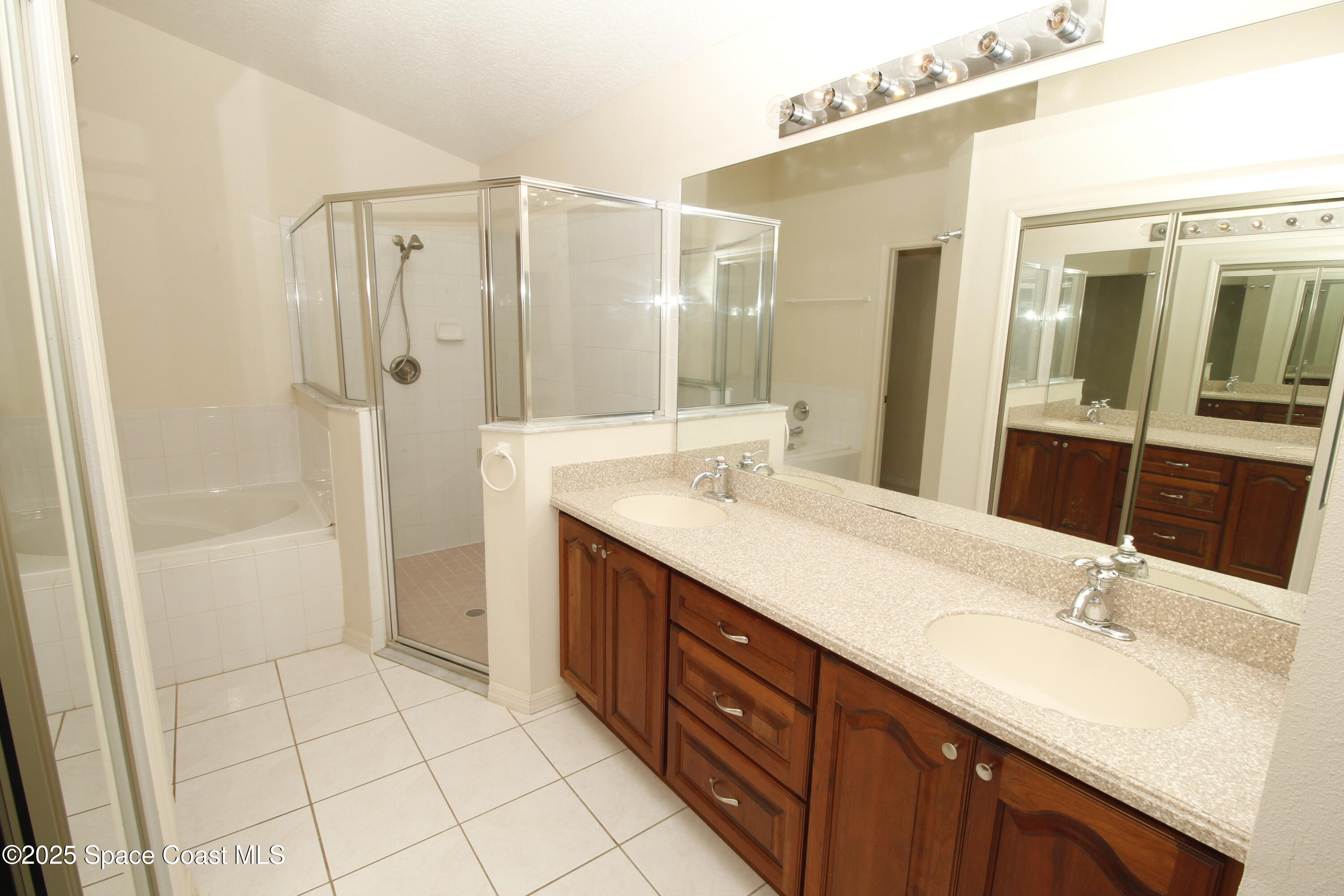 7971 Daventry Drive Melbourne, FL 32940 - Photo 17 of 22 a bathroom with a double vanity sink mirror and shower