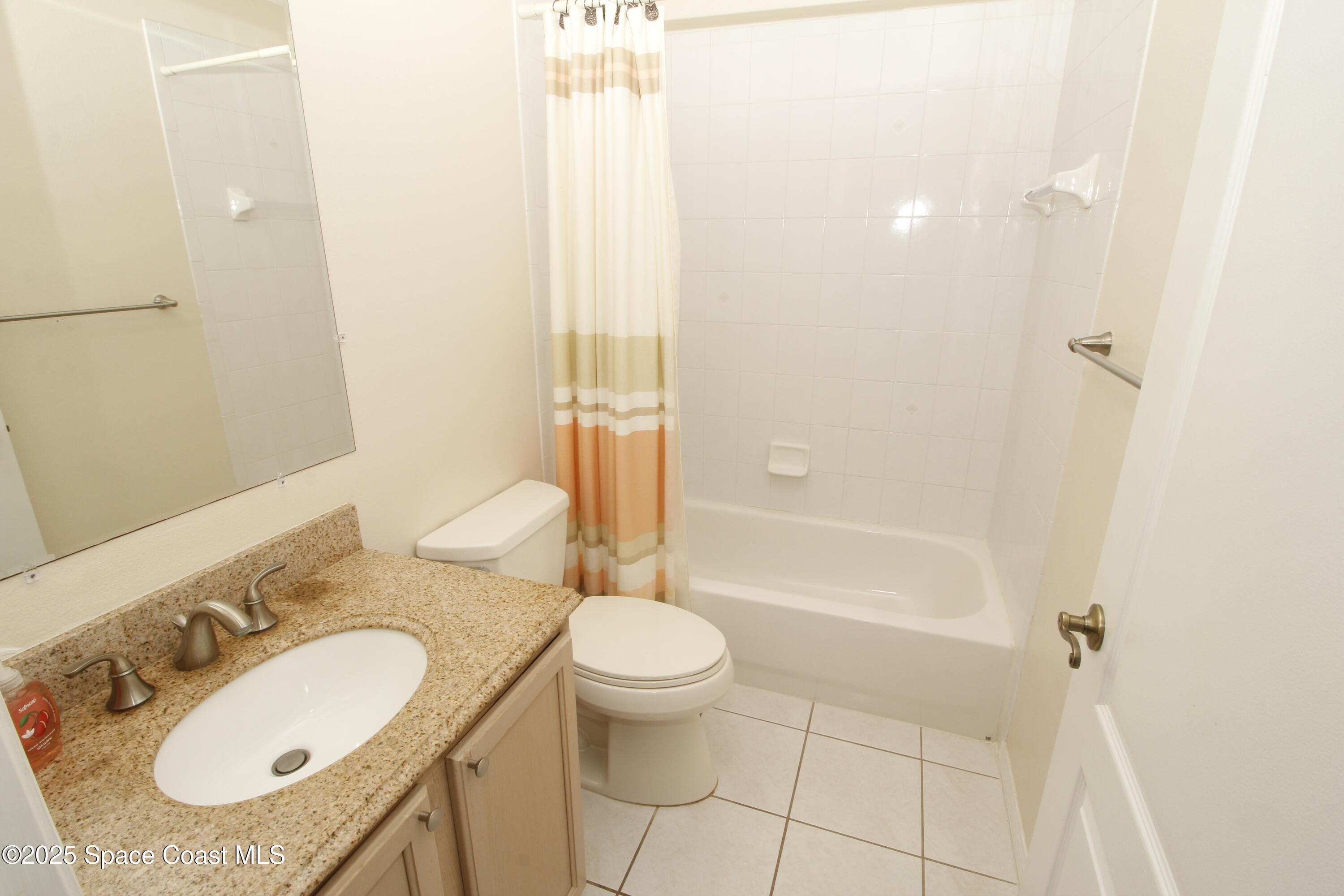 7971 Daventry Drive Melbourne, FL 32940 - Photo 4 of 22 a bathroom with a granite countertop sink toilet and shower