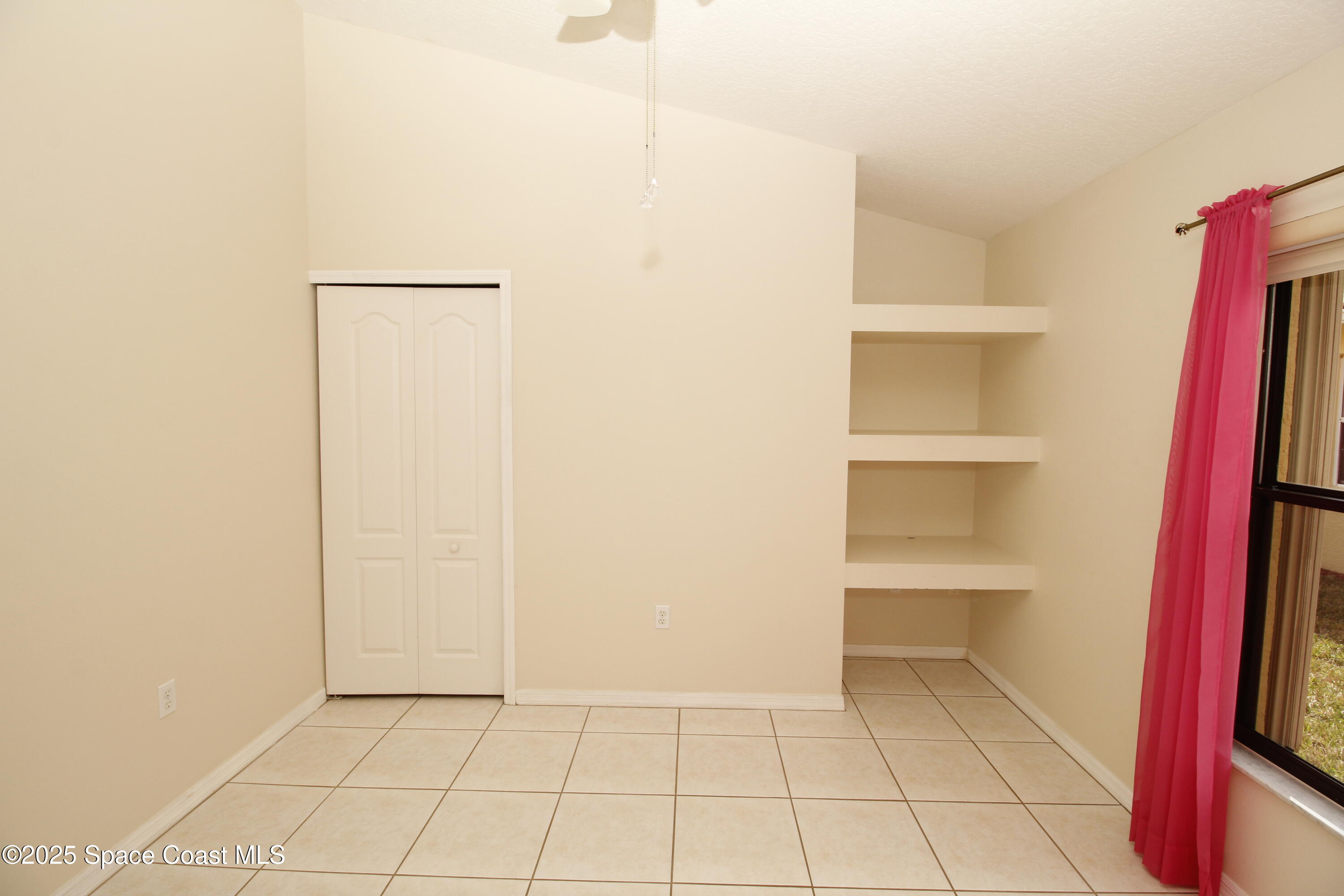 7971 Daventry Drive Melbourne, FL 32940 - Photo 5 of 22 a view of walk in closet with empty racks