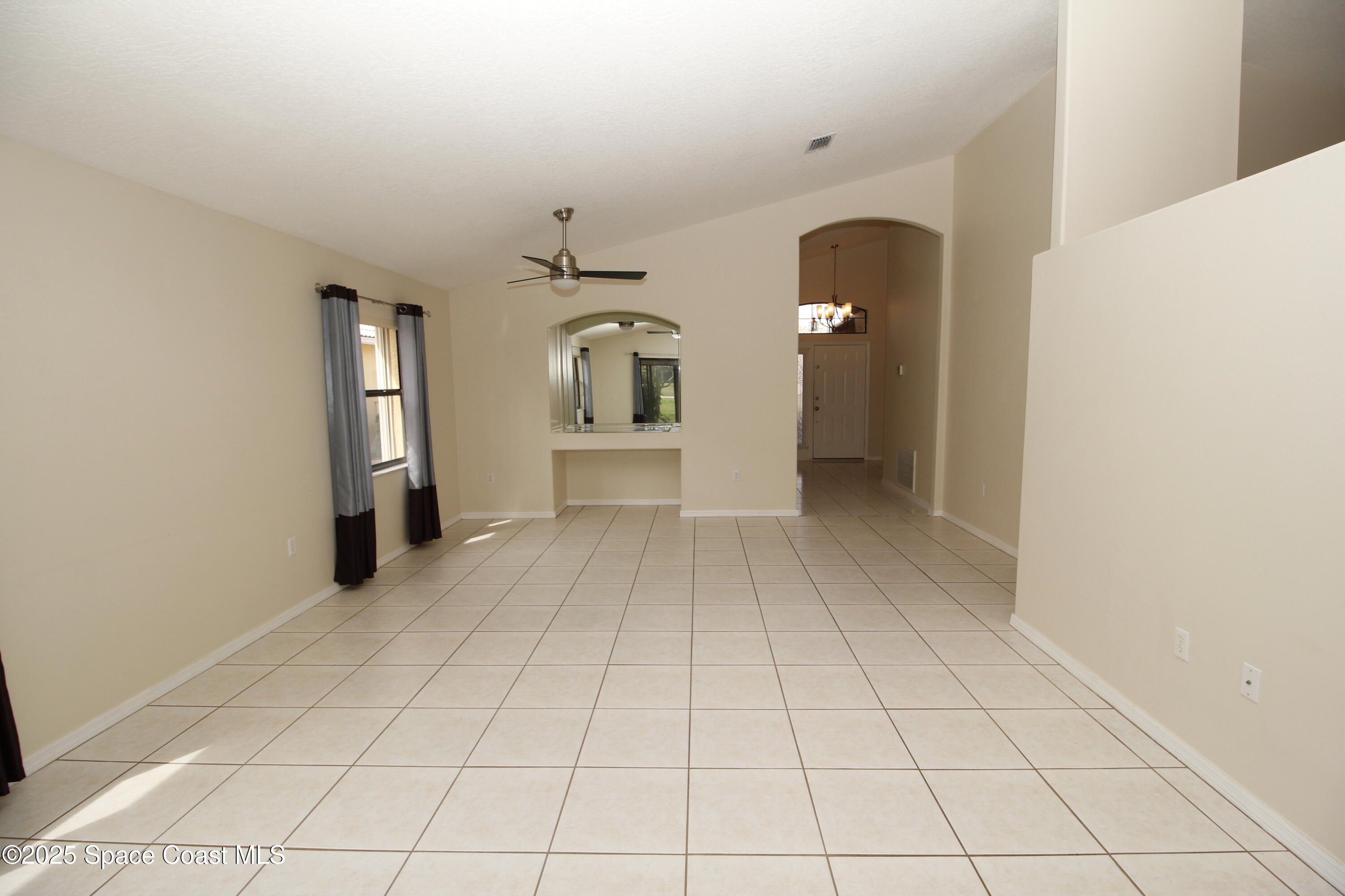 7971 Daventry Drive Melbourne, FL 32940 - Photo 8 of 22 a view of a hallway with wooden floor and a living room