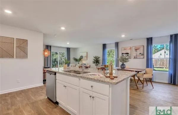 a view of living room with granite countertop furniture and wooden floor