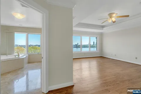 a view of walk in closet with empty racks