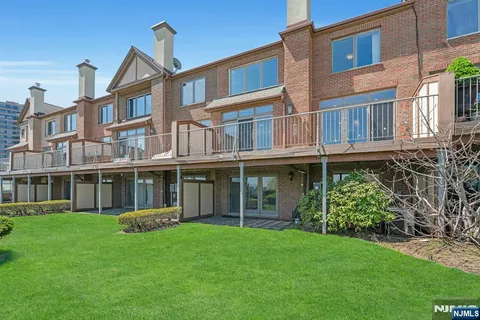 a view of an apartment with a garden and deck