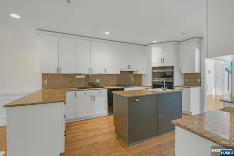 a kitchen with stainless steel appliances granite countertop a sink and a granite counter tops