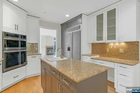 a living room with furniture kitchen view and a large window