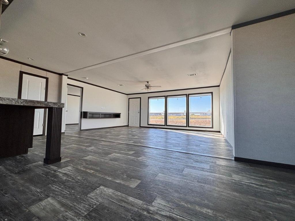 149 Castellana Way Elgin, TX 78621 - Photo 18 of 18 a view of an empty room with window and wooden floor