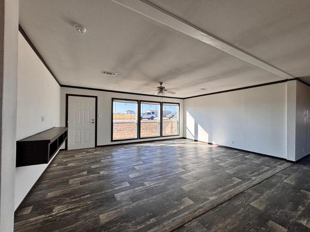 149 Castellana Way Elgin, TX 78621 - Photo 13 of 18 a view of empty room with wooden floor and fan