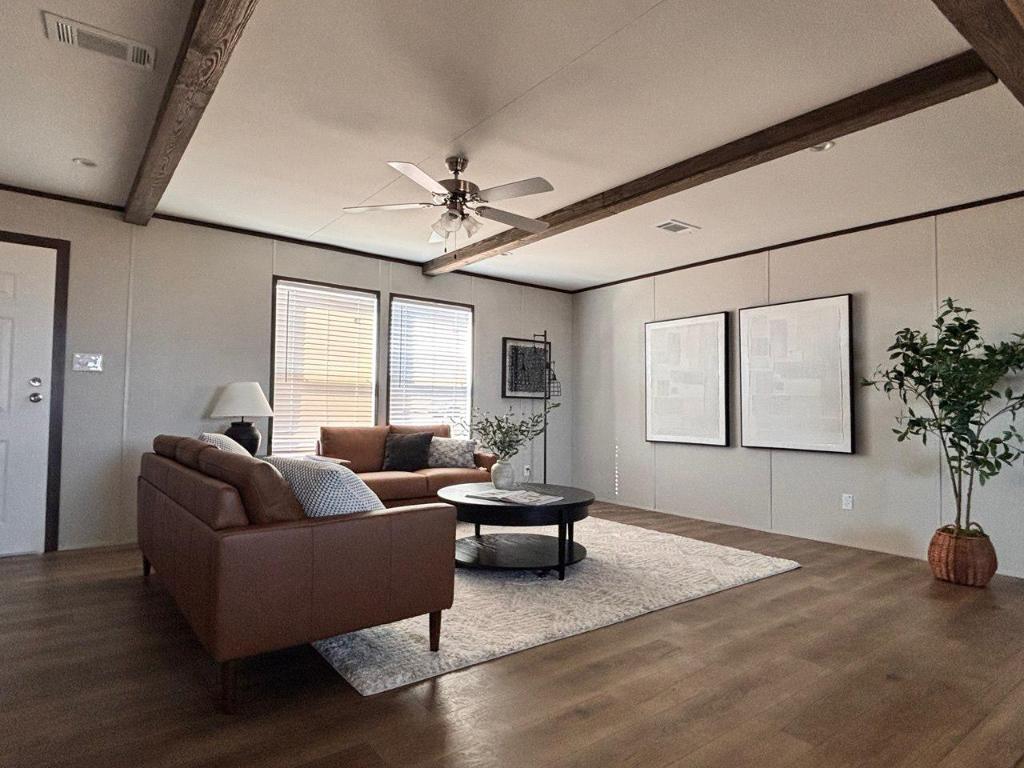 149 Castellana Way Elgin, TX 78621 - Photo 3 of 18 a living room with furniture and potted plant
