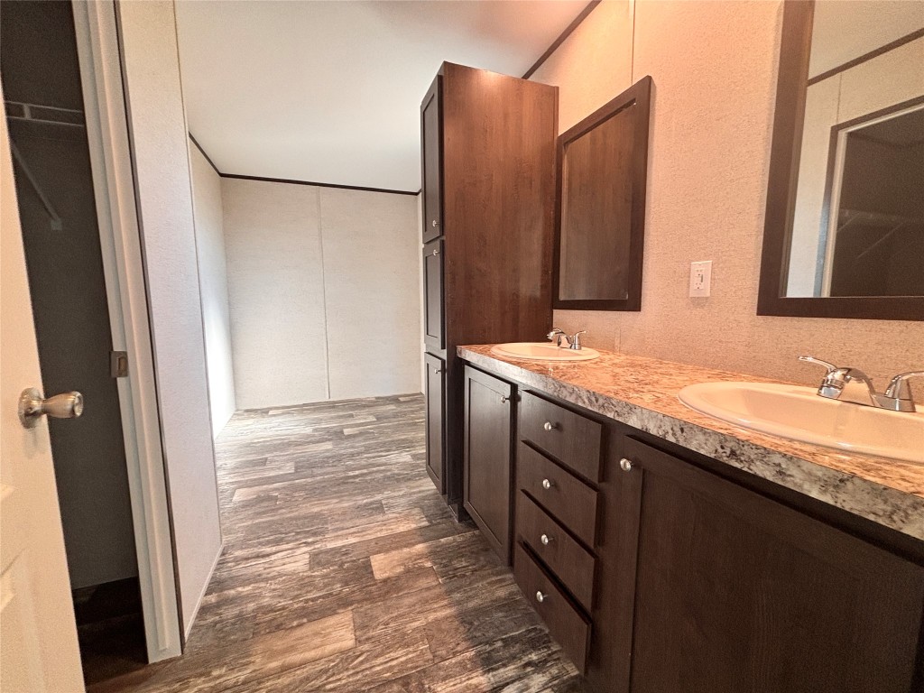 149 Castellana Way Elgin, TX 78621 - Photo 6 of 18 a bathroom with a granite countertop sink and a mirror
