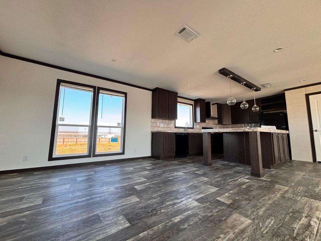 149 Castellana Way Elgin, TX 78621 - Photo 7 of 18 a view of a kitchen with a sink and dishwasher next to a large window