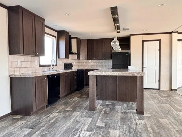 a kitchen with a sink a stove and cabinets