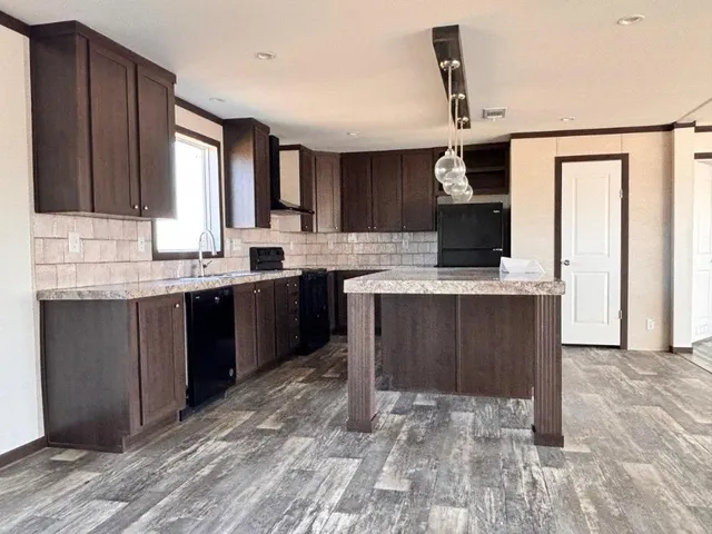 a kitchen with a sink a stove and cabinets