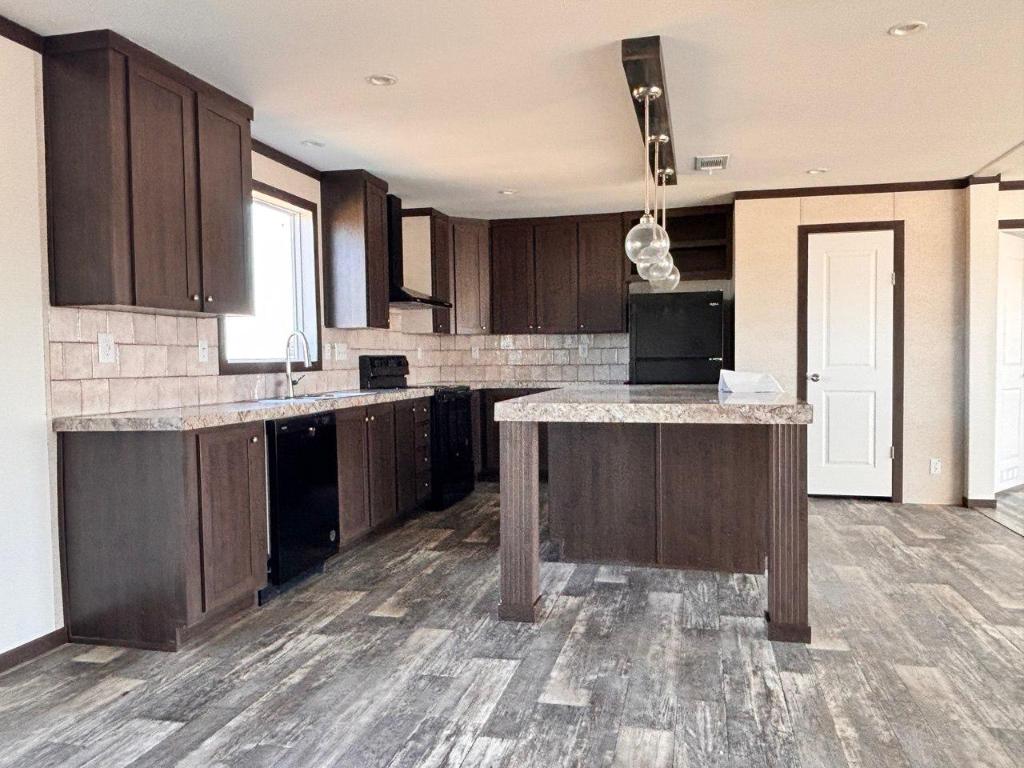 149 Castellana Way Elgin, TX 78621 - Photo 10 of 18 a kitchen with a sink a stove and cabinets