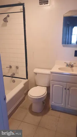 a bathroom with a toilet a sink a vanity and mirror