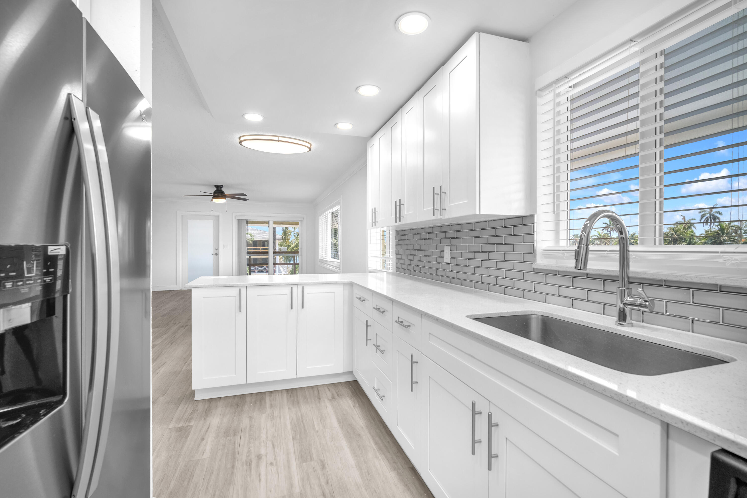 1015 Spanish River Road Boca Raton, FL 33432 - Photo 12 of 28 a kitchen with a sink and refrigerator