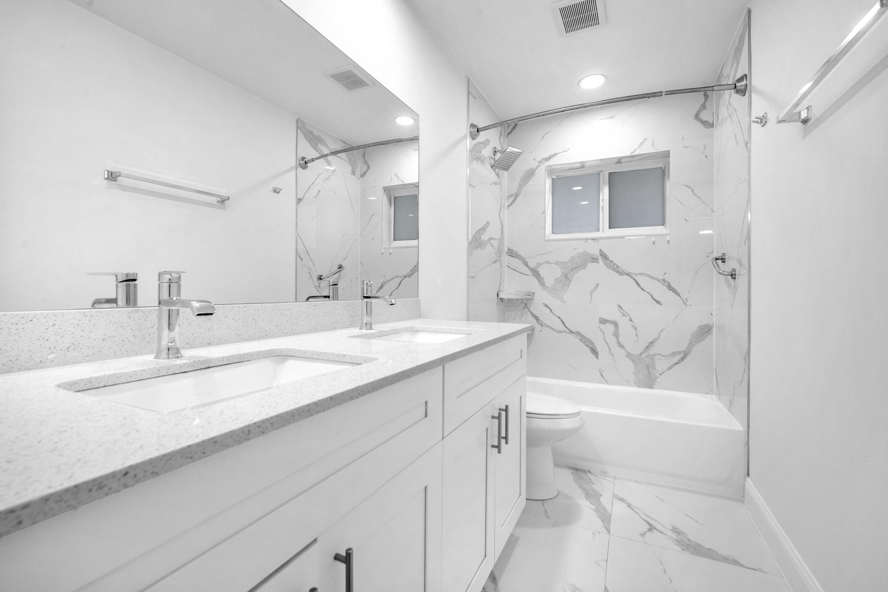 1015 Spanish River Road Boca Raton, FL 33432 - Photo 17 of 28 a bathroom with a granite countertop sink mirror vanity bathtub and toilet