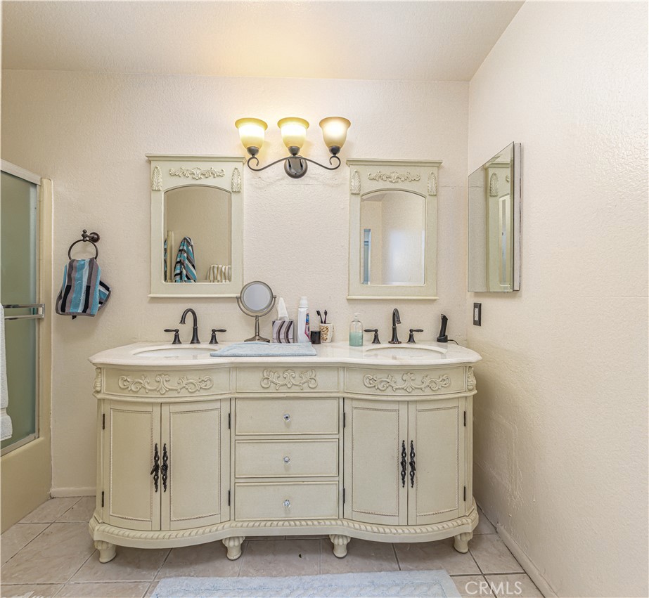 3730 South Bear Street, Unit E Santa Ana, CA 92704 - Photo 11 of 43 a bathroom with a sink a mirror and a light fixture