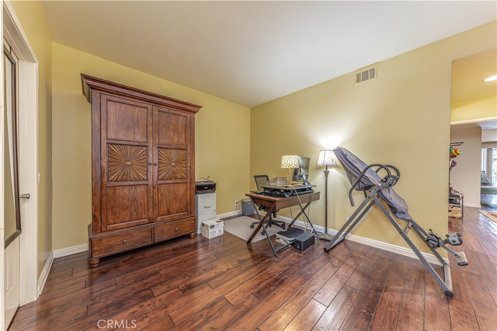 3730 South Bear Street, Unit E Santa Ana, CA 92704 - Photo 13 of 43 a view of a room with wooden floor air conditioner and windows