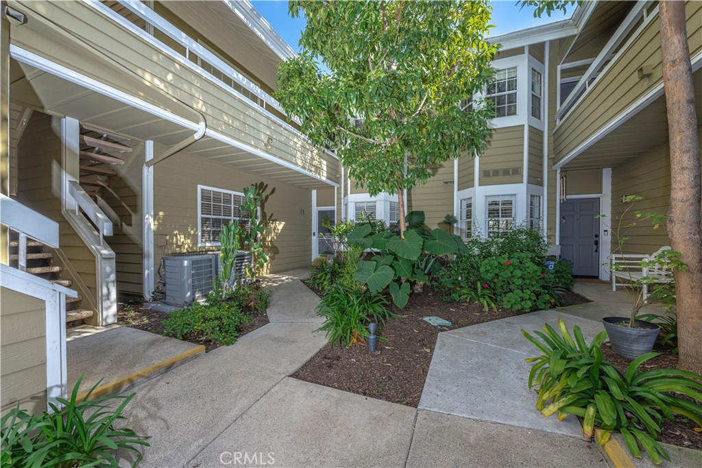 3730 South Bear Street, Unit E Santa Ana, CA 92704 - Photo 20 of 43 a front view of a house with a garden