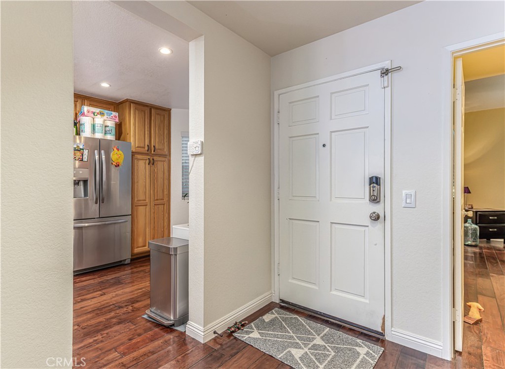 3730 South Bear Street, Unit E Santa Ana, CA 92704 - Photo 24 of 43 a view of kitchen space with wooden floor electronic appliances and windows