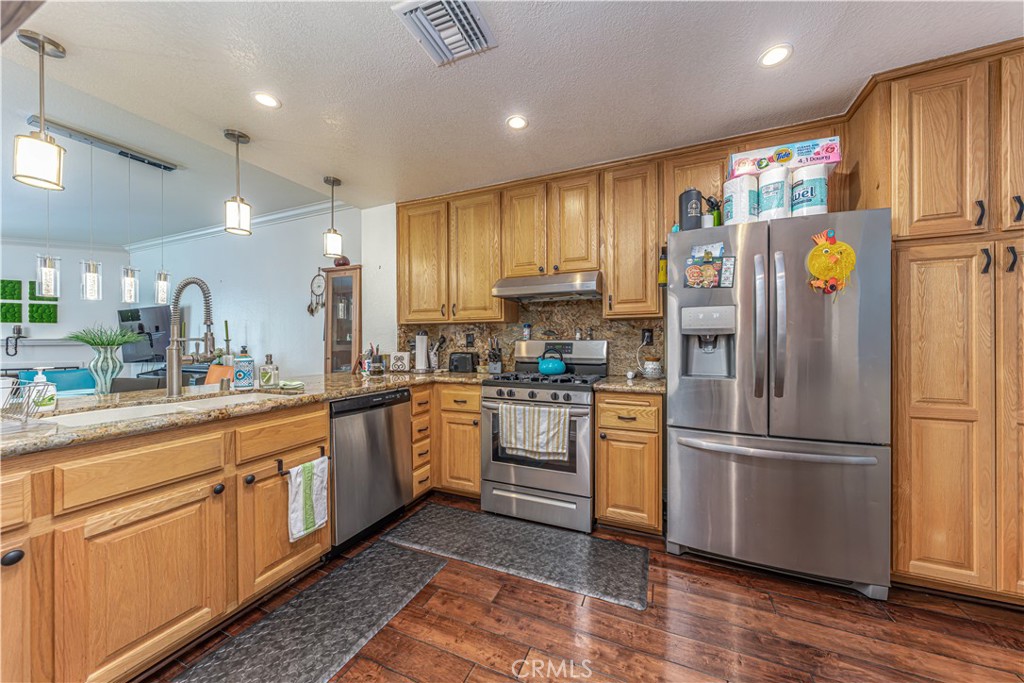 3730 South Bear Street, Unit E Santa Ana, CA 92704 - Photo 25 of 43 a kitchen with a refrigerator and a sink