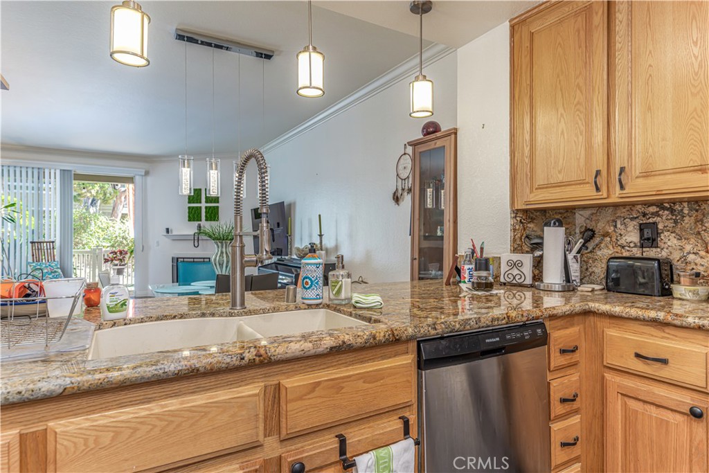 3730 South Bear Street, Unit E Santa Ana, CA 92704 - Photo 27 of 43 a kitchen with granite countertop a sink a counter top space appliances and cabinets