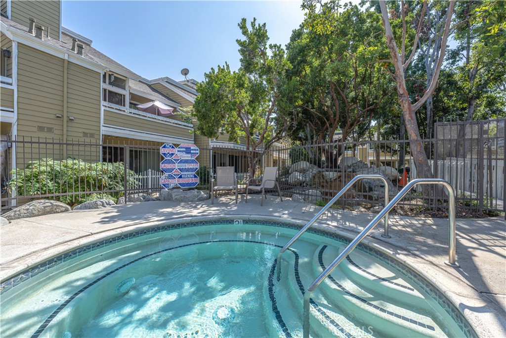 3730 South Bear Street, Unit E Santa Ana, CA 92704 - Photo 34 of 43 a swimming pool with outdoor seating and yard