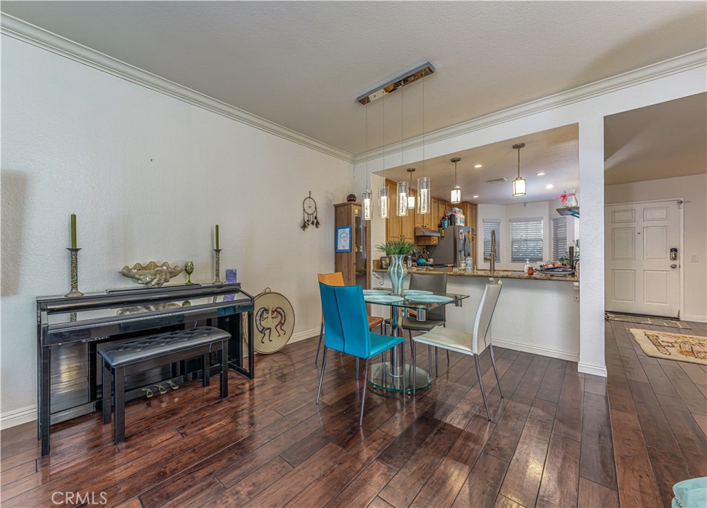 3730 South Bear Street, Unit E Santa Ana, CA 92704 - Photo 6 of 43 a view of a dining room with furniture and wooden floor