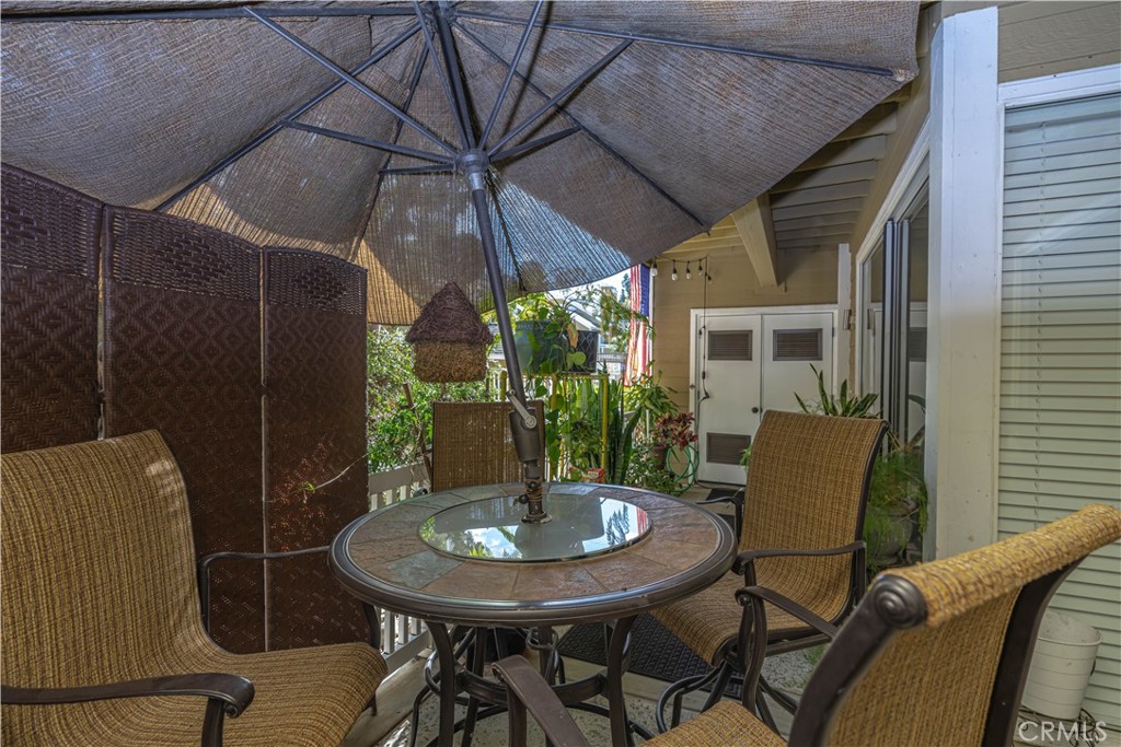 3730 South Bear Street, Unit E Santa Ana, CA 92704 - Photo 9 of 43 a outdoor dining space with furniture and umbrella