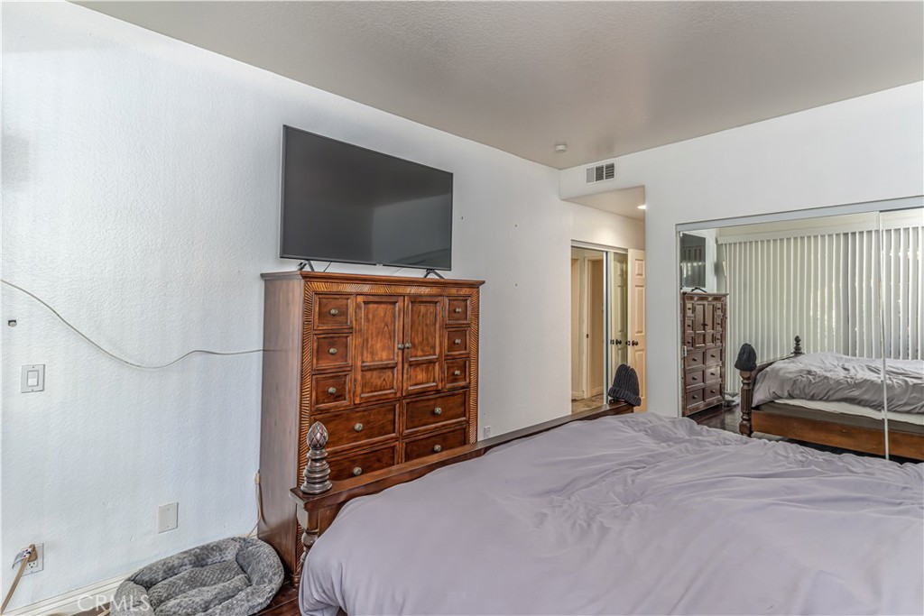 3730 South Bear Street, Unit E Santa Ana, CA 92704 - Photo 10 of 43 a bedroom with a bed and furniture