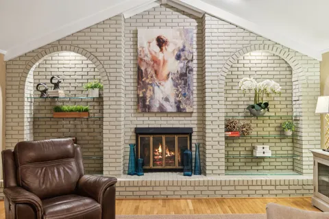 a view of a balcony with wooden floor and outdoor seating