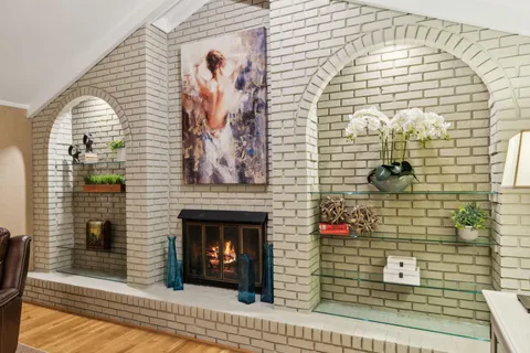 a view of empty room with wooden floor and window