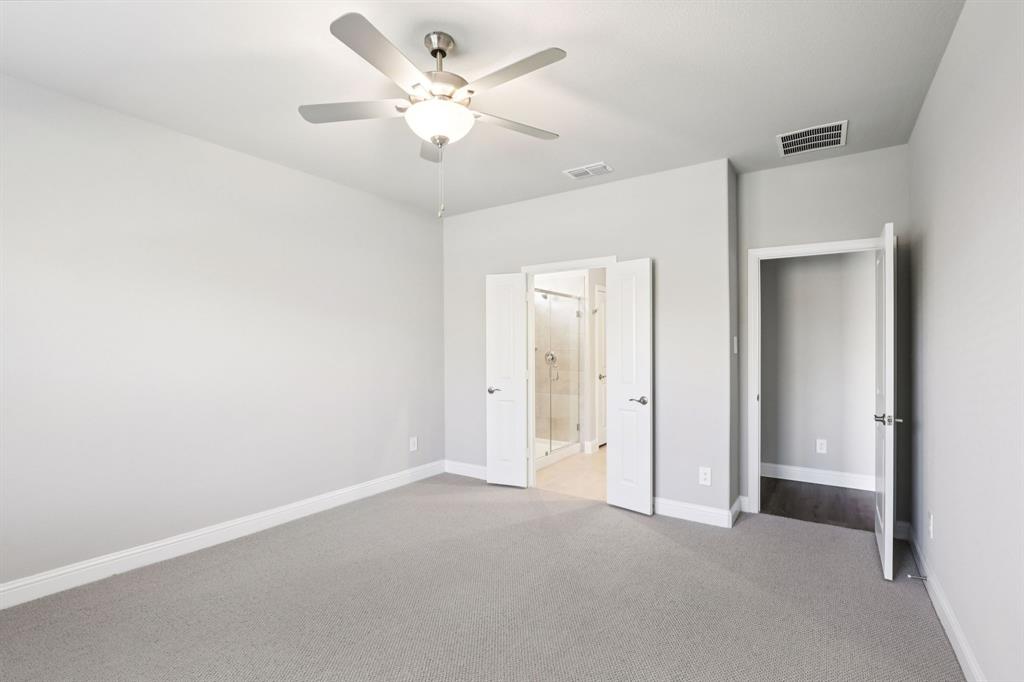 1636 Arches Road Anna, TX 75409 - Photo 12 of 22 an empty room with a ceiling fan and a bathroom